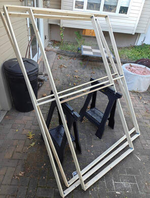 three finished wooden frames, one thinner and two wider.