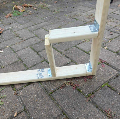 close up of the corner of one frame, with a wooden square framed in.