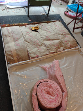 one wooden flat, on the floor, with fiberglass insulation affixed to the inside.