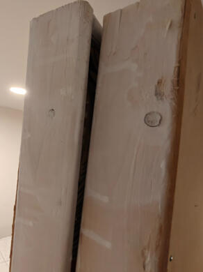 two mismatched frame edges the edges of two wooden frames, side by side. They're impossible to make flush because of wood warp.