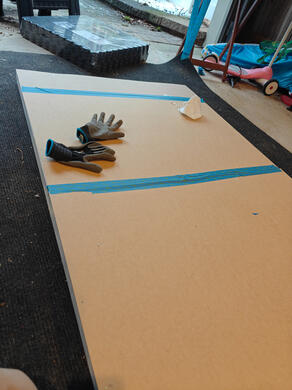 frame with MDF backing one 3-foot wooden flat, on the floor, with MDF backing attached. underneath the MDF is fiberglass insulation, and fabric on the other side.